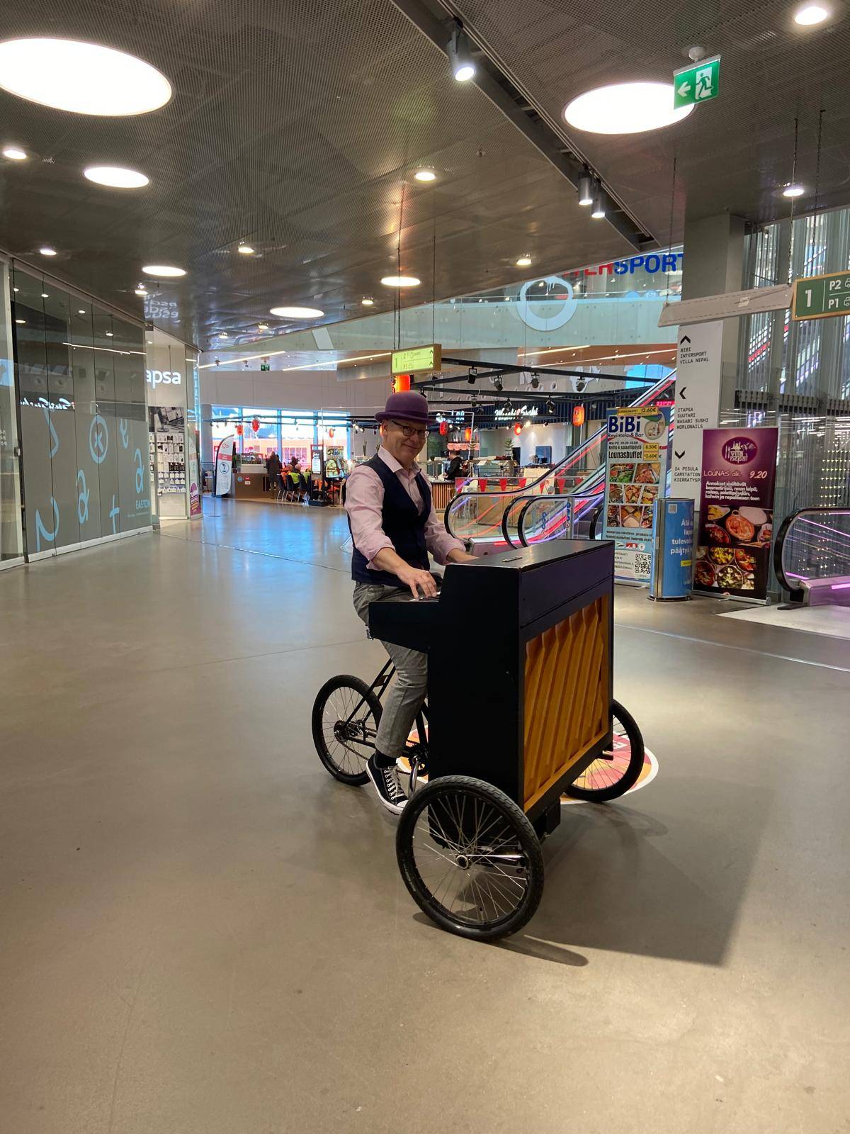 Pyöräpiano ja elävää musiikkia kauppakeskuksessa – Event Heavenin tapahtumatuotanto Helsingissä Pyöräpositiivari esiintyy kauppakeskuksessa – tapahtumatuotanto Helsinki
